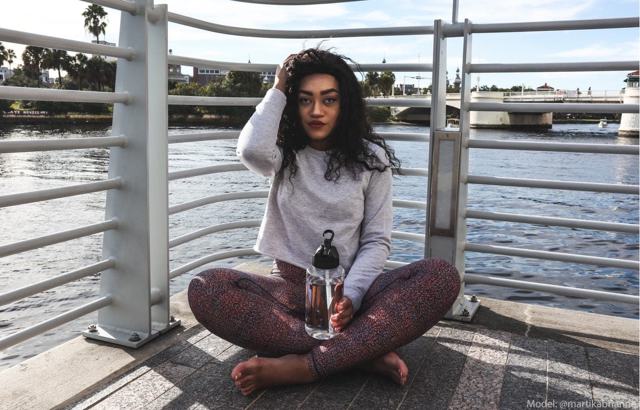 Rose gold initial water bottle styled with a casual workout look